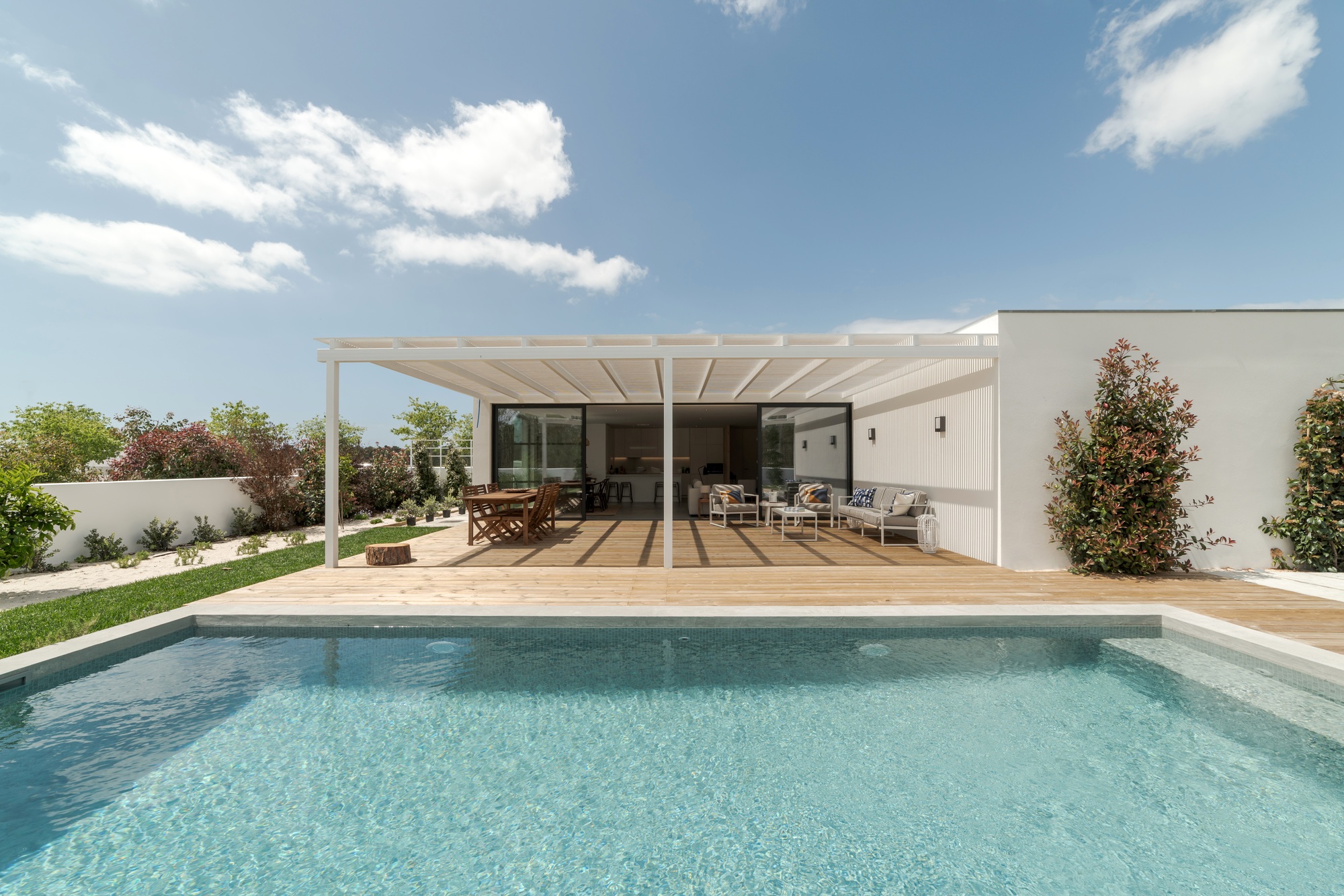 Modern house with garden swimming pool and wooden deck